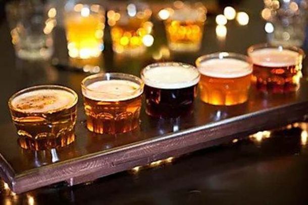 A flight of beer samples on a brewery tour